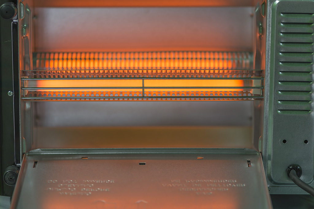 In a toaster oven, how do you clean the heating element?