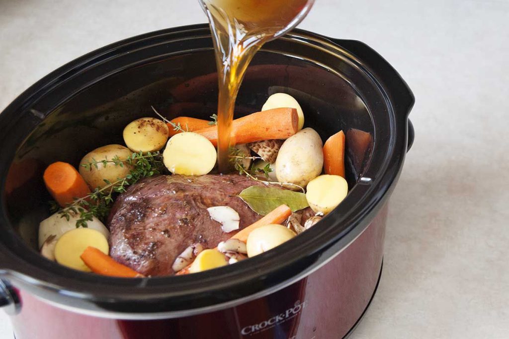What are the signs that a crock-pot roast is done?