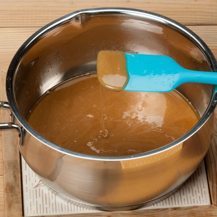 How do I get crystallized caramel out of my dishes and stoves?