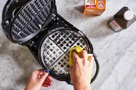 Can I clean my waffle maker with water if I unplug it?