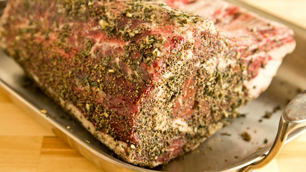 How should prime rib be seasoned?